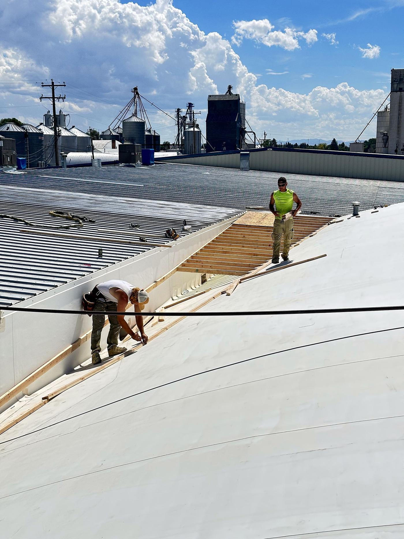 Crew coating a metal roof