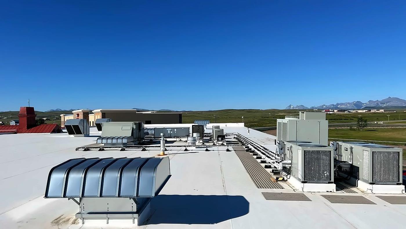 Row of rooftop HVAC units showing the roof's scale (inspection, Oct 2022)